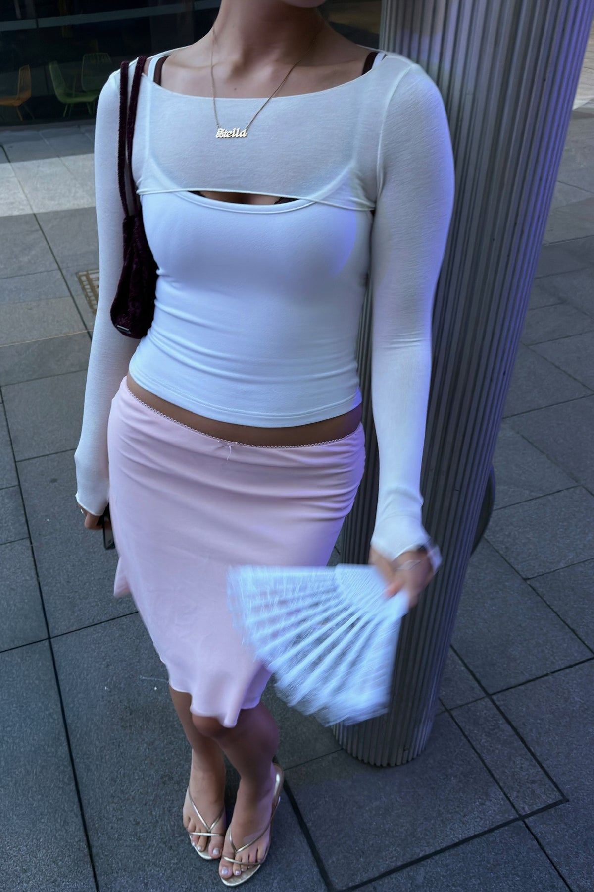 Woman in white long-sleeve dance bolero and tank top.