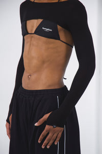 Black lightweight bolero worn over dance bikini and black dance sweatpants