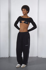 Person wearing a black dance outfit on a white background