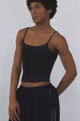 Person wearing a black outfit with white text on a white background