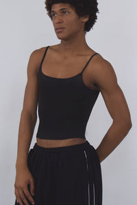 Person wearing a black outfit with white text on a white background