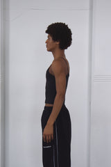 Person wearing a black outfit with white text on a white background