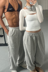 Two people wearing matching outfits with sweatpants and tops.