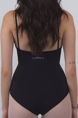Black dance leotard with swan logo worn by a person on a plain background