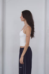 white compression tank top and dark baggy dance pants 